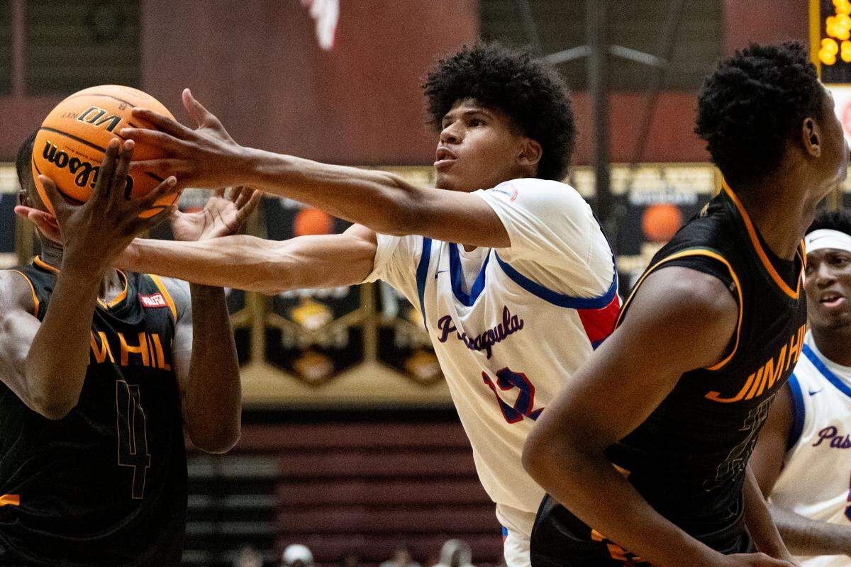 Pascagoula’s Adam Griffin (12) reaches out to recover a rebound during a boys basketball game at Pearl River Community College on Wednesday, Feb. 25, 2026.