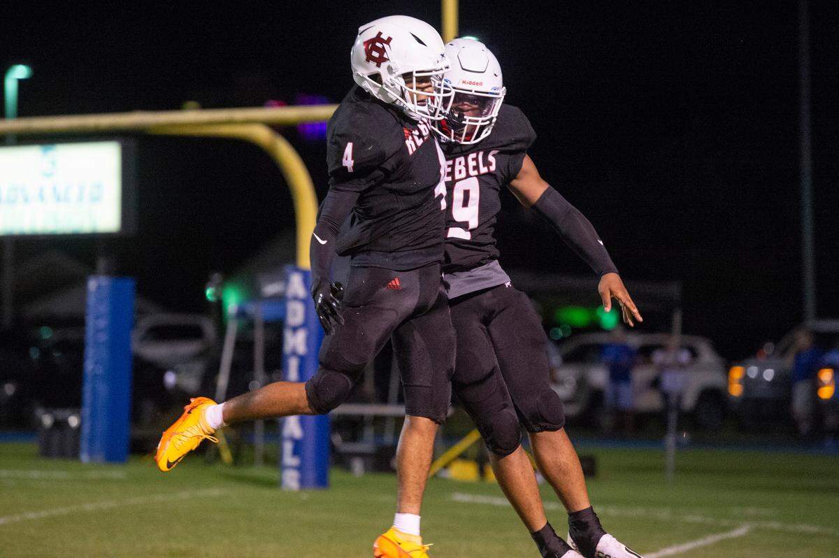 Harrison Central’s Jonah Armstrong (#4) and Des Smith (#9) celebrate after scoring a touchdown against Oak Grove during a game at Milner Stadium in Gulfport on Friday, Aug. 26, 2022.