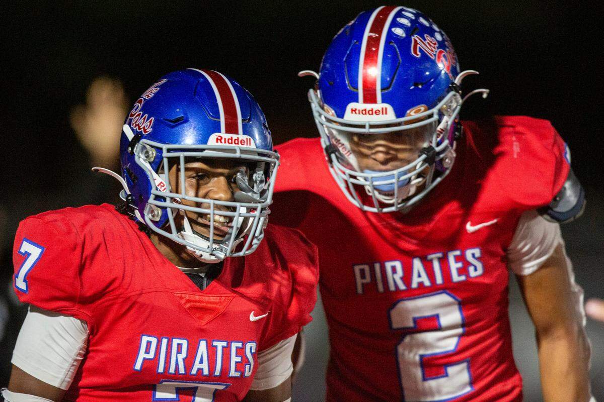 Pass Christian’s Anthony James and Jaquez Alexander celebrate after a touchdown scored by James during a game against Moss Point at Pass Christian High School in Pass Christian on Friday, Oct. 13, 2023.