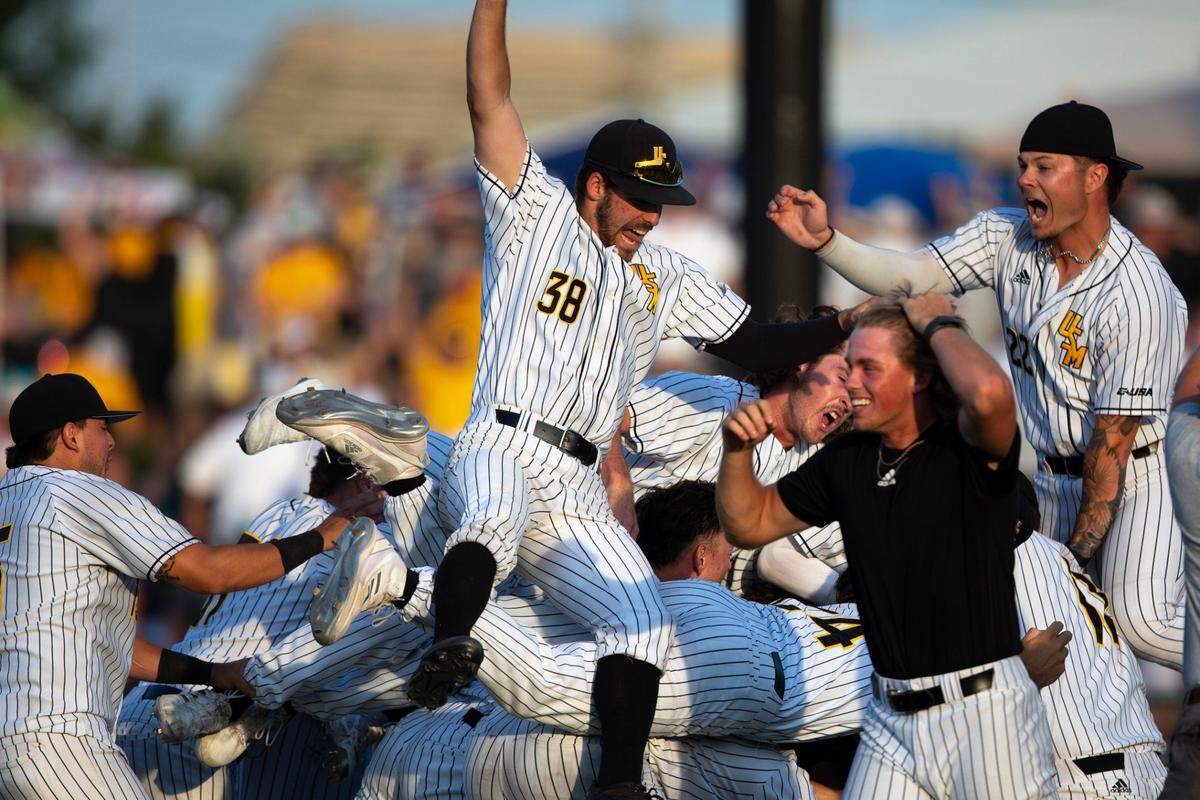 Southern Miss players dog pile on the pitchers mound after defeating LSU 8-7 in the NCAA Regionals at Pete Taylor Park in Hattiesburg on Monday, June 6, 2022. Southern Miss will advance to super regionals.