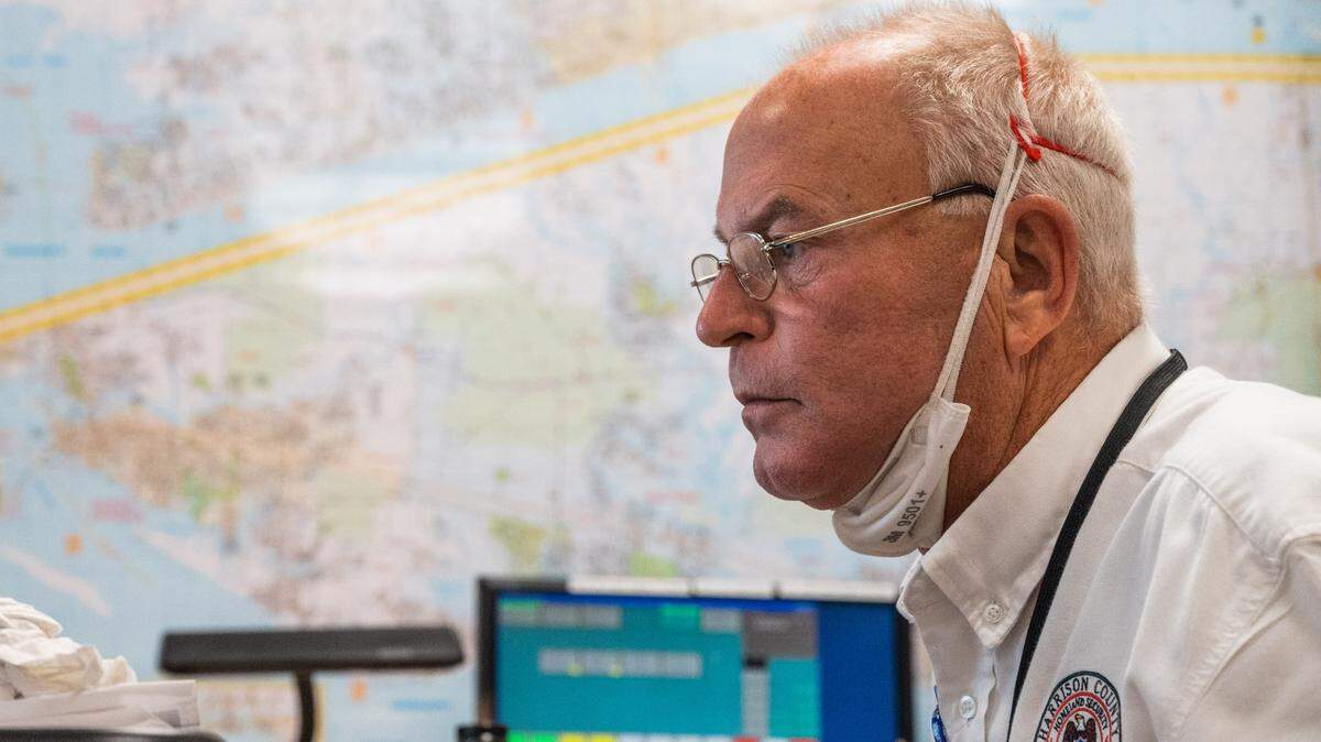 Rupert Lacy, the Director of the Harrison County Emergency Operations Center in Gulfport, monitors the development of Hurricane Sally as a map of the Mississippi Coast hangs in the background on Monday, Sept. 14, 2020.