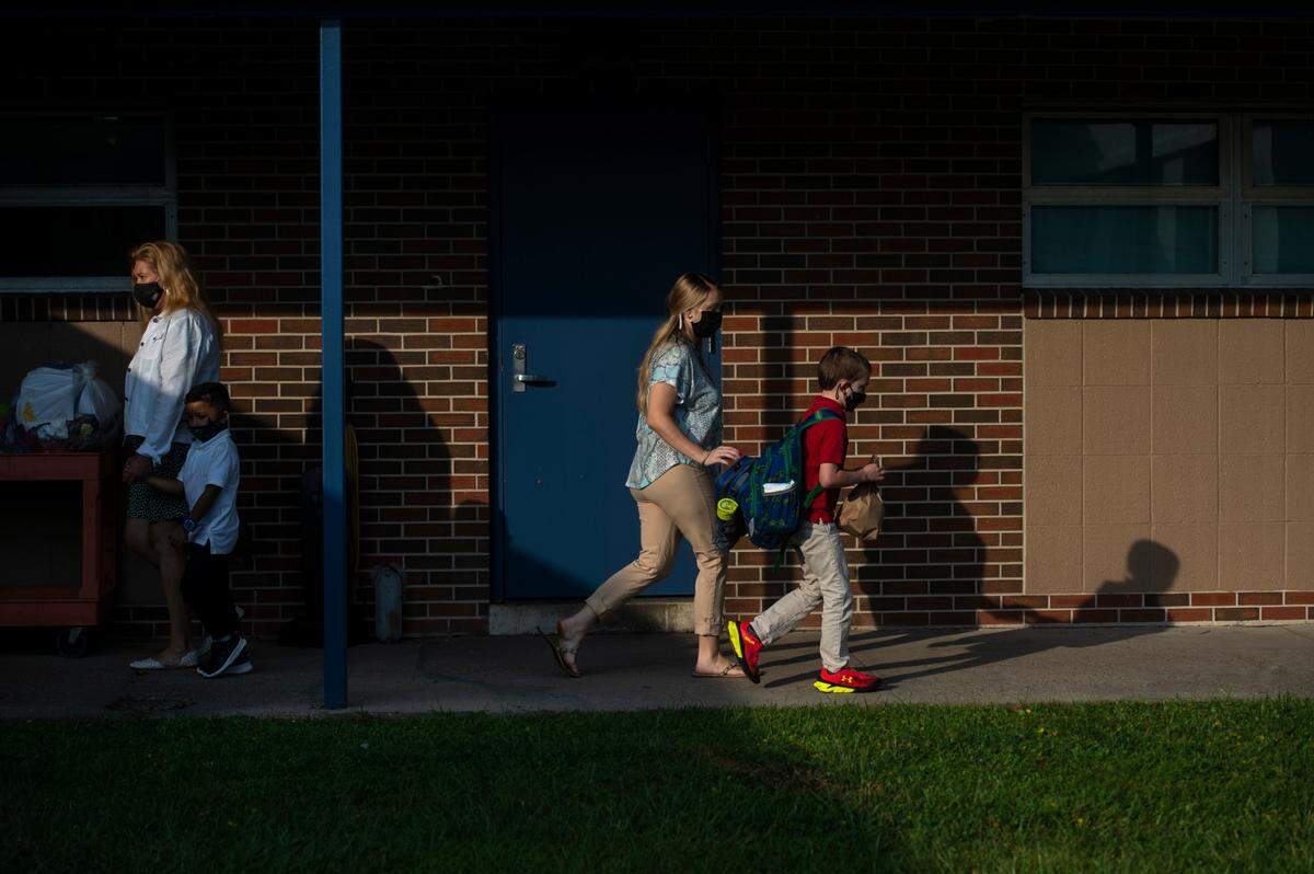 Students are escorted to their classrooms by staff on the first day of school at Gautier Elementary on Monday, July 5, 2021. Students have to stay within their pod, or a group of a few classes, to prevent COVID-19 spread.