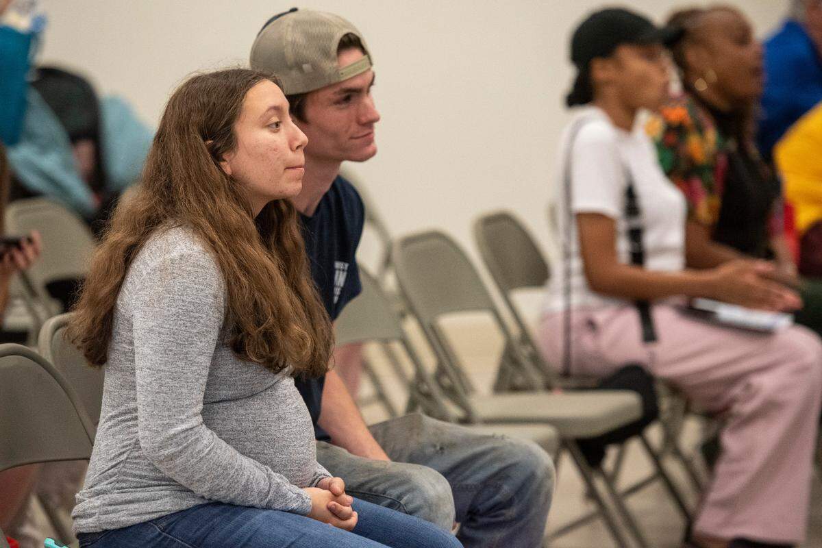 Kalli Garcia and Gavin Rexroad listen to speakers during a community baby shower event at Lyman Community Center in Gulfport on Thursday, Nov. 14, 2024.