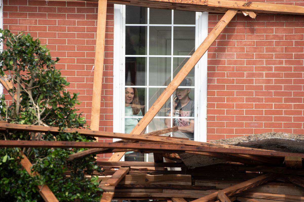 Bank employees survey damage of Merchants and Marine Bank in Moss Point on Tuesday, June 20, 2023, after a tornado damaged the building on Monday, trapping workers inside.