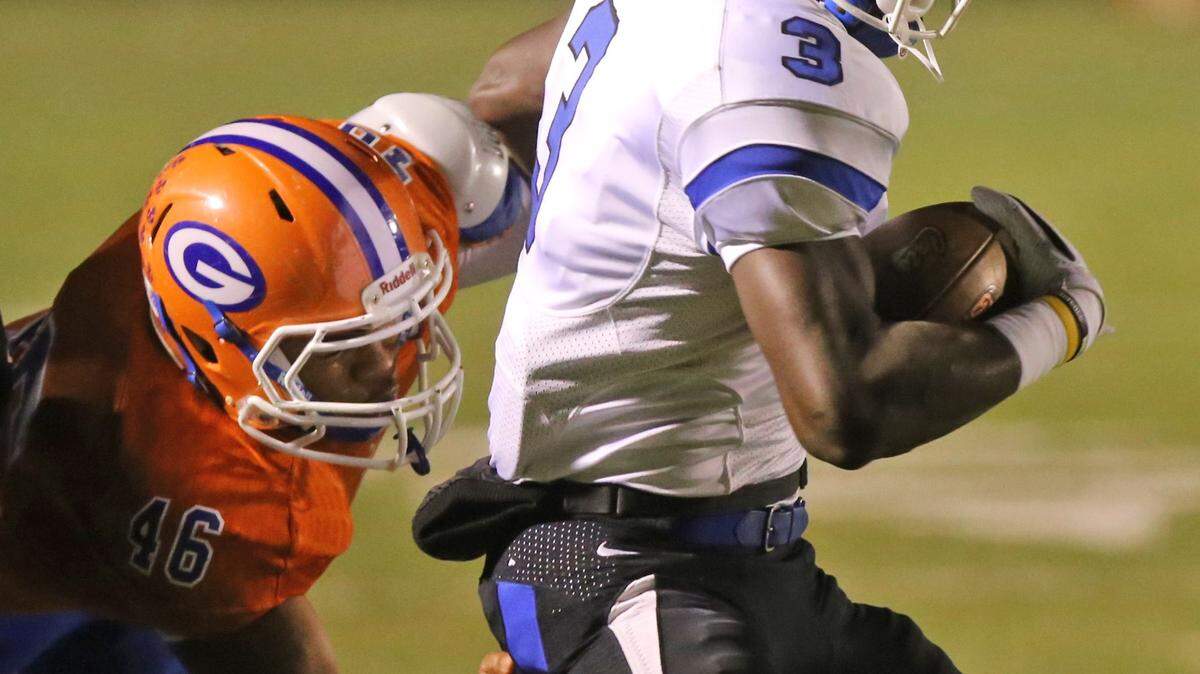 JOHN FITZHUGH/SUN HERALD 
 Gulfport linebacker Gabriel Williams tries to tackle Meridian wide receiver Daniel Crowell during the second quarter of their 6A playoff game at Milner Stadium in Gulfport on Friday Nov. 13, 2013.