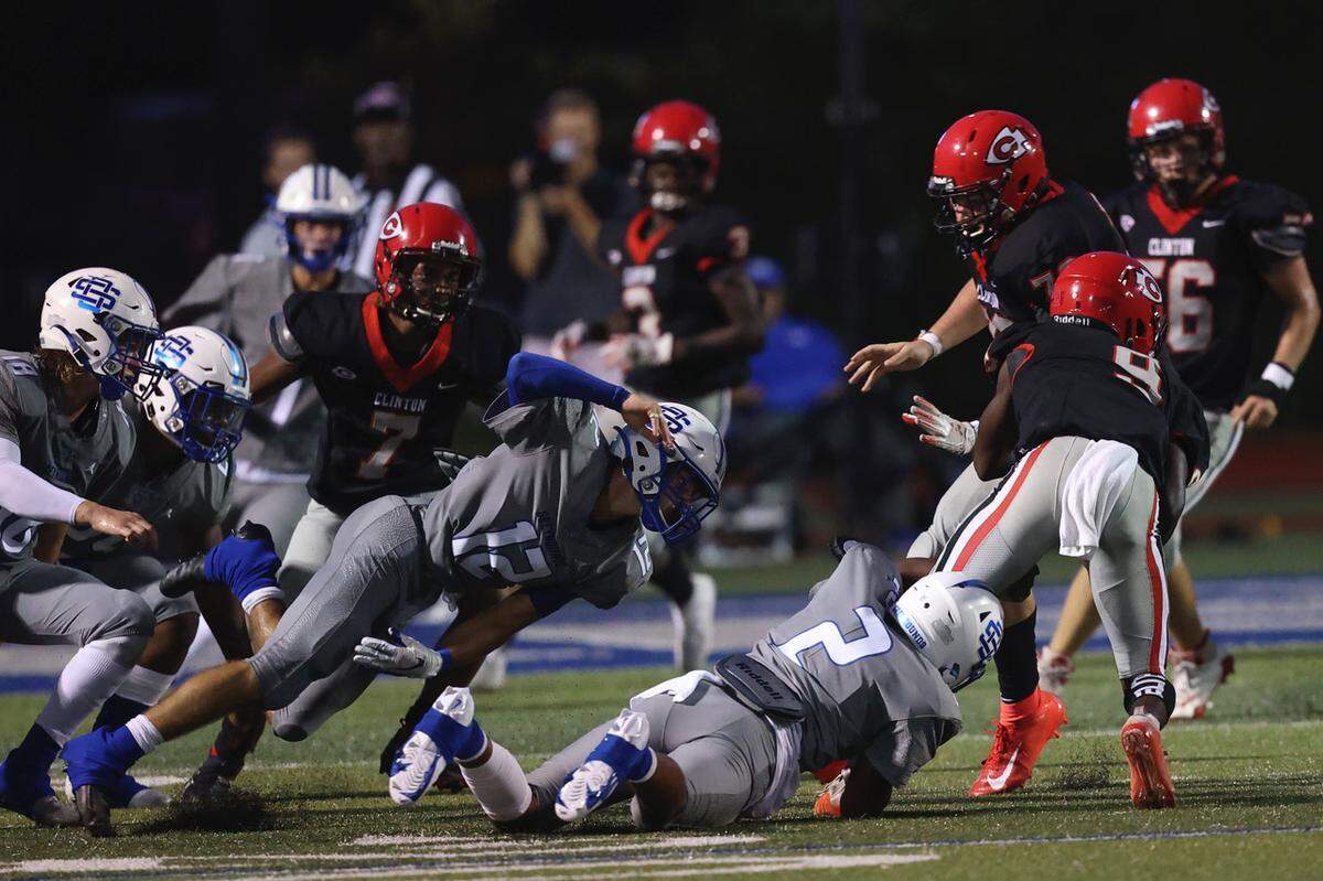Ocean Springs Greyhounds linebacker Trace Carter (2) tackles Clinton Arrows Jordyn Battee (9).
