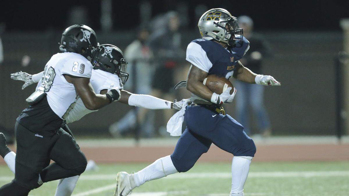Mississippi Gulf Coast Community College running back Omni Wells runs away from the East Mississippi defense on Nov. 2, 2019, in Perkinston.