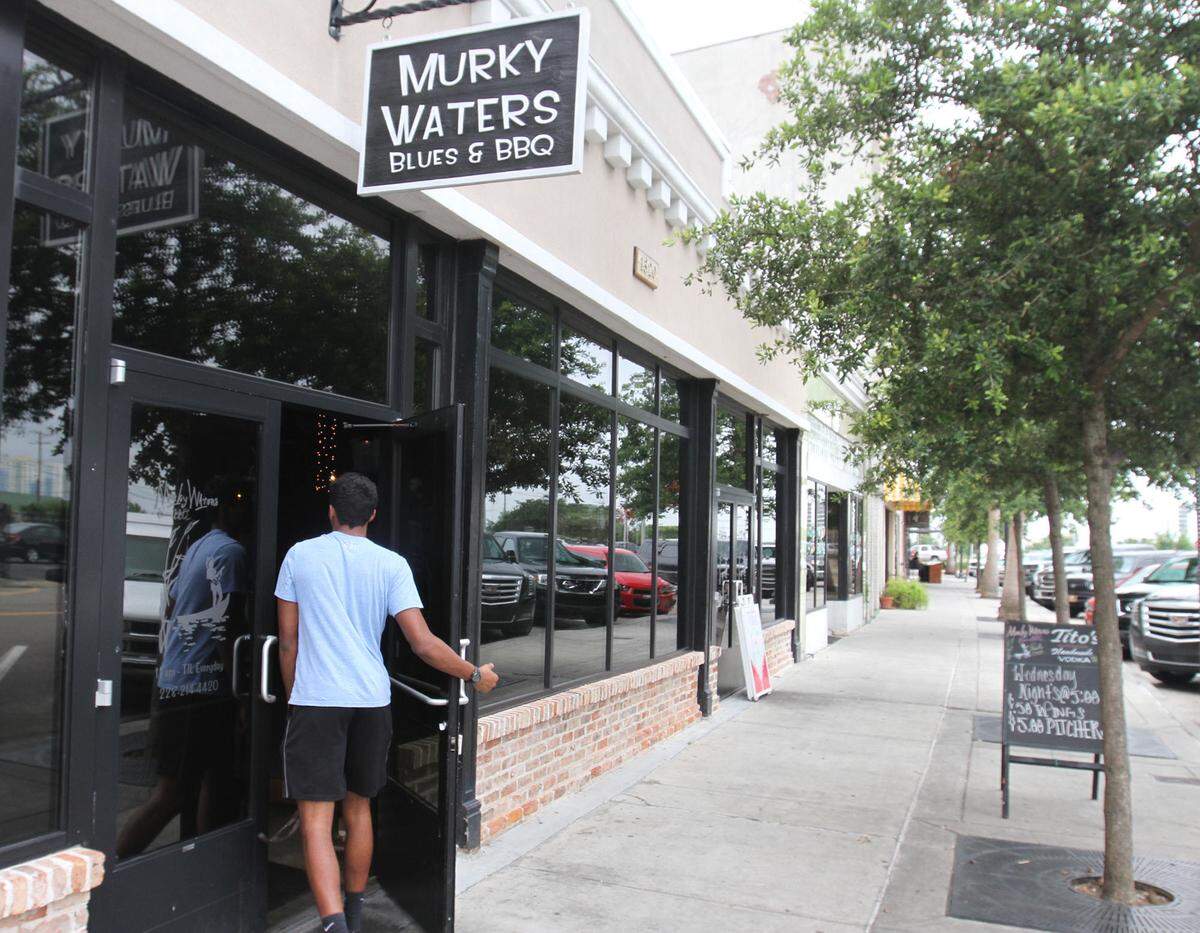 A customer arrives for lunch at Murky Waters Blues & BBQ in Gulfport on Monday June 6, 2016.