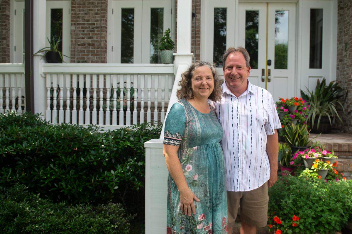 Heidi and Dan Hoye pose for a portrait in front of their home in Biloxi on Wednesday, May 14, 2025. The Hoyes bought the home with. waterfront view as a short-term rental. While the city approved, neighbors filed a lawsuit, tying up their project.,