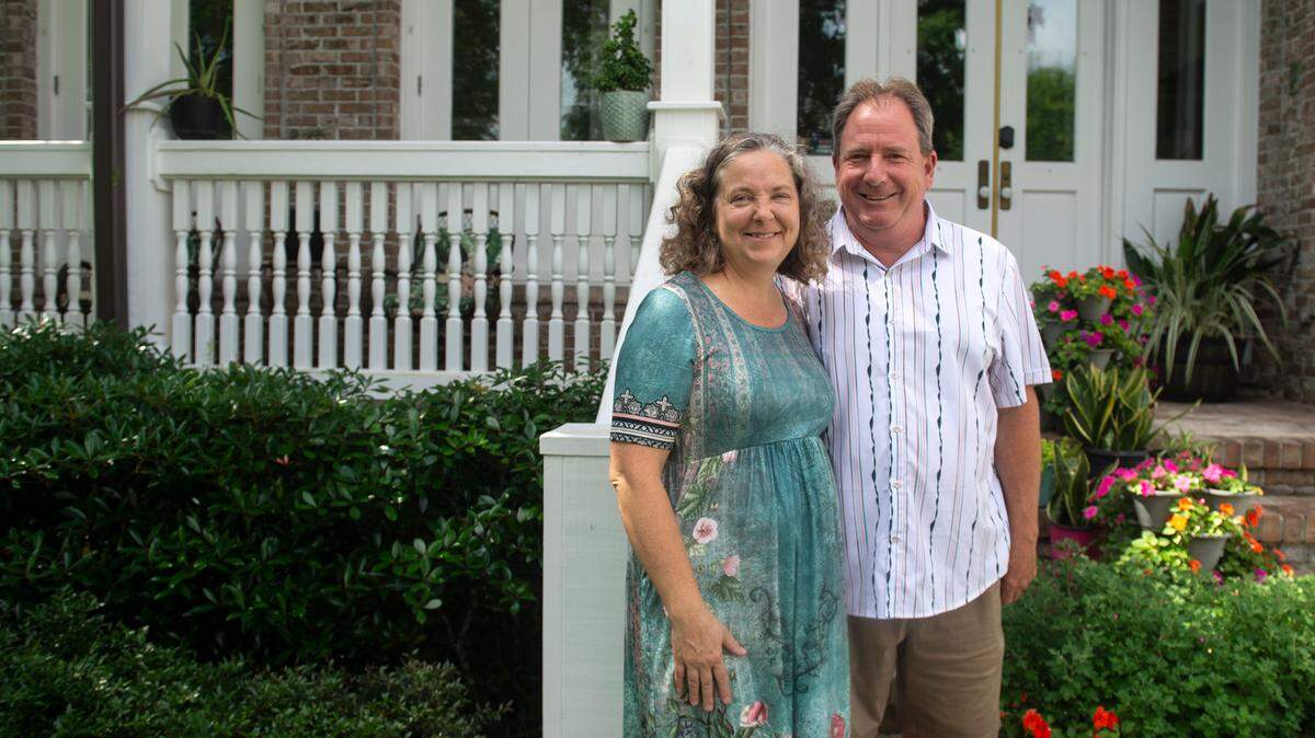 Heidi and Dan Hoye pose for a portrait in front of their home in Biloxi on Wednesday, May 14, 2025. The Hoyes bought the home with the intention of turning it into a bed and breakfast, but permission has been stalled in court after neighbors appealed the city’s approval.