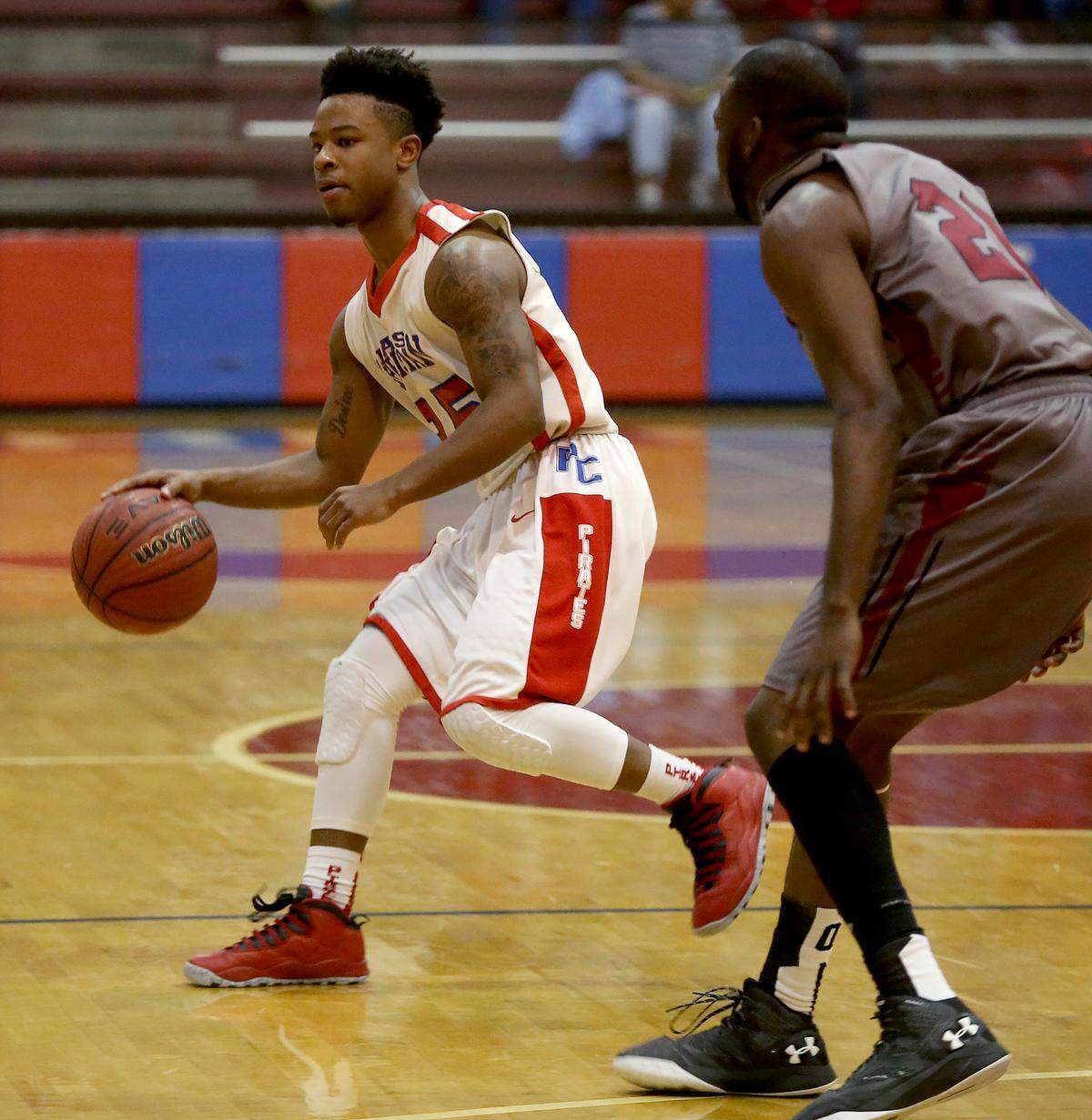AMANDA McCOY/SUN HERALDPass Christian's Maliq Leaks dribbles around Lawrence County's Phillip Moore during the second round of the Class 4A state playoffs on Saturday, Feb. 27, 2016, at Pass Christian High.