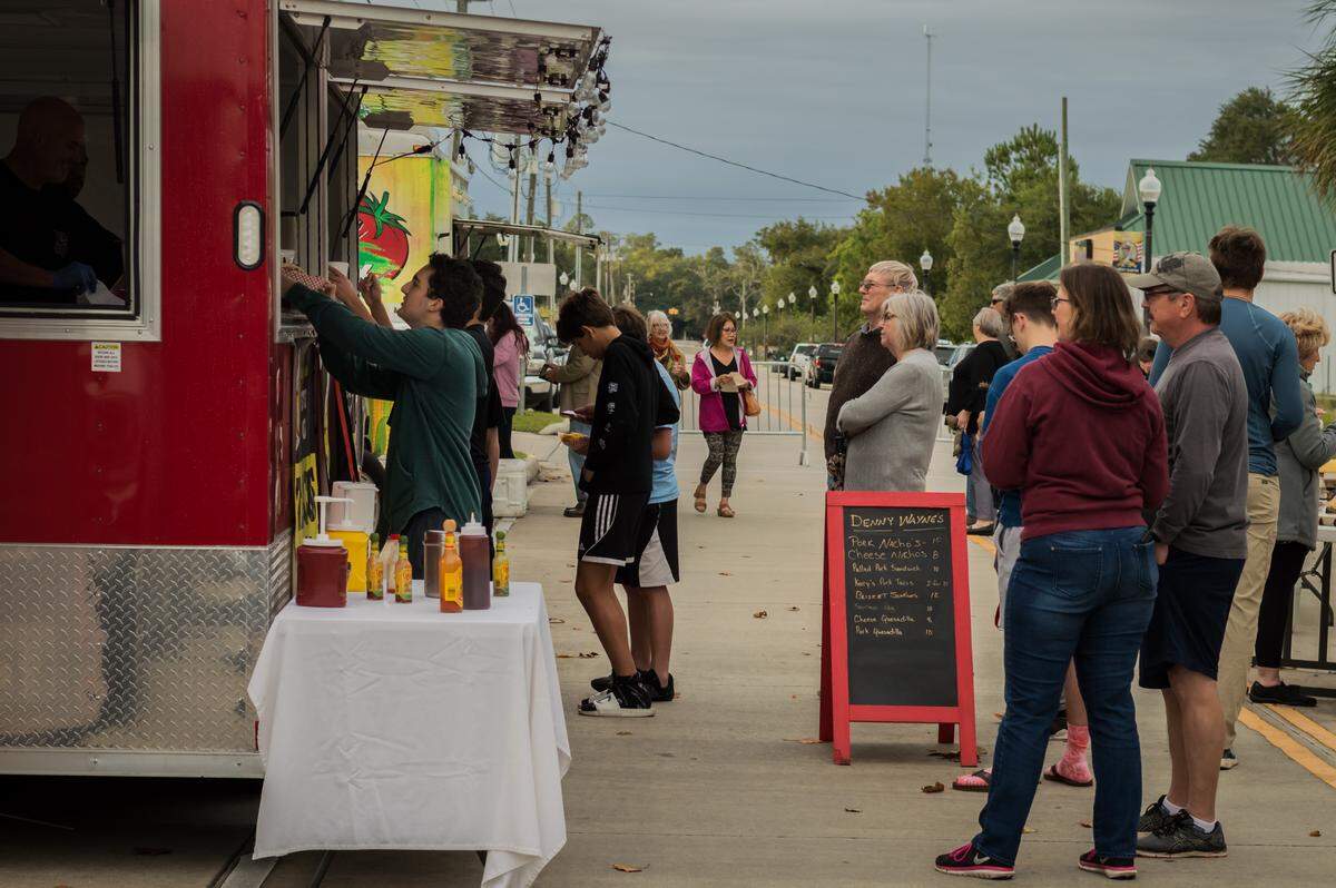 Crowds waiting in line to make their order on Coleman Street at the Food Truck Friday in Waveland in October 2019.