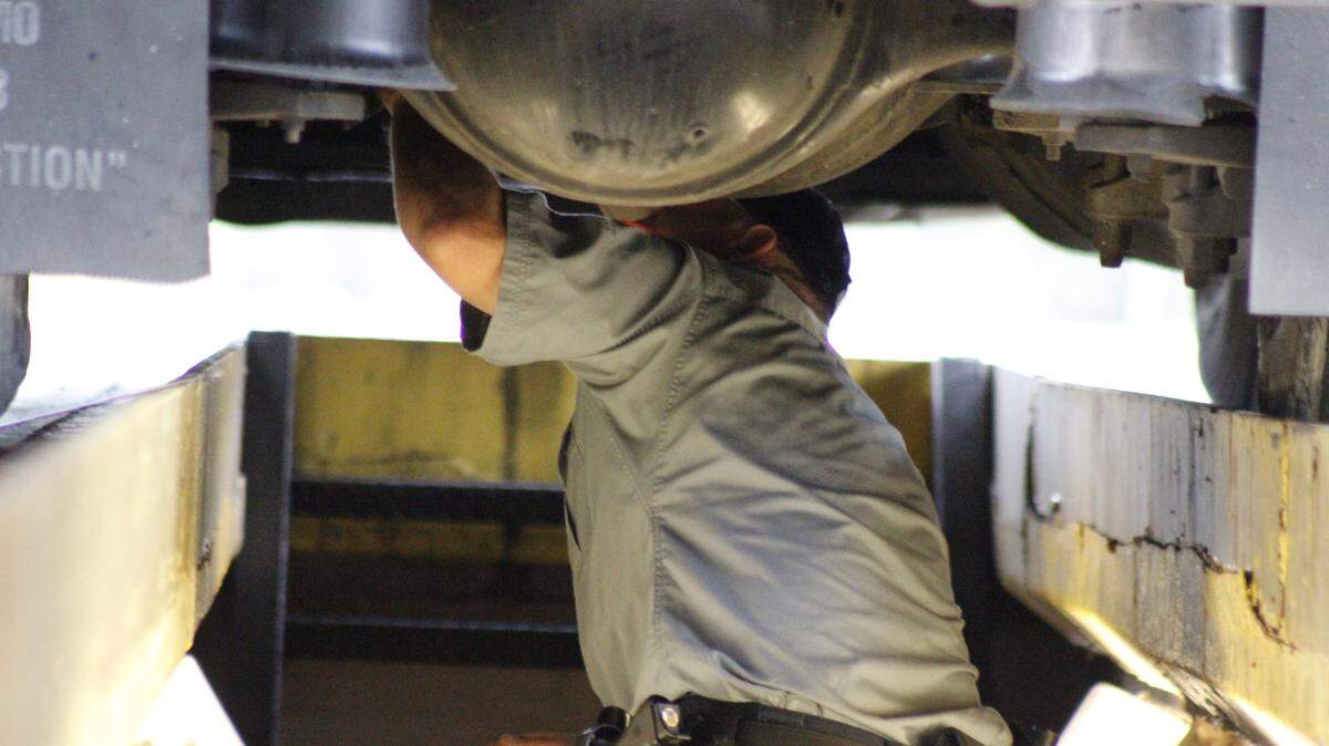 WESLEY MULLER/SUN HERALD 
 Mississippi Department of Transportation Sgt. Randy Jones inspects the undercarriage of an 18-wheeler Wednesday at the Interstate 10 inspection station in Bay St. Louis. Dec. 9, 2015.
