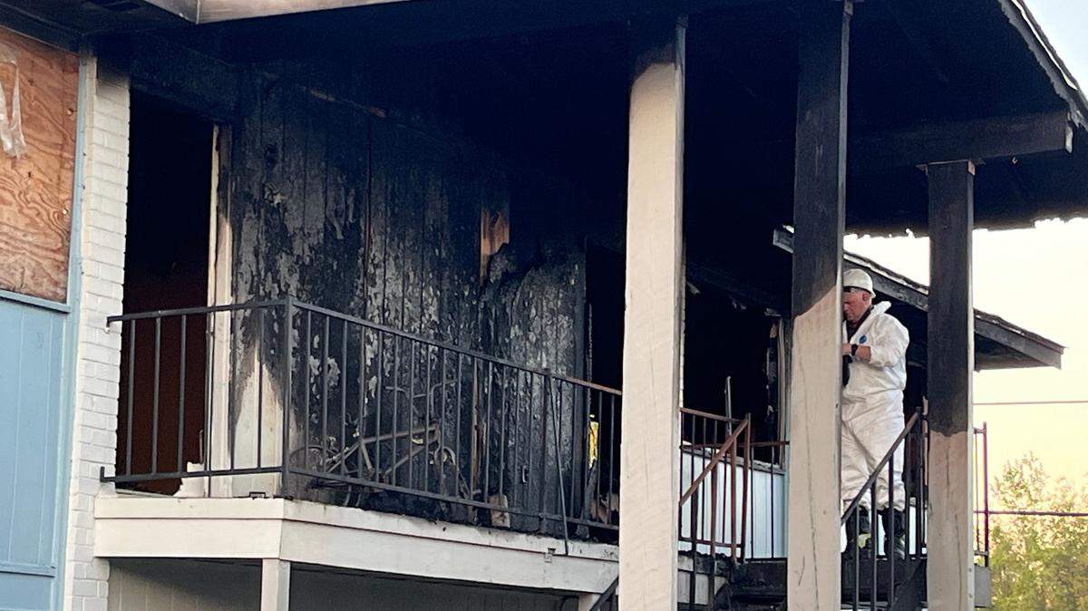 Investigators survey the scene Friday morning after a fire at the Southwind Apartments in Biloxi.