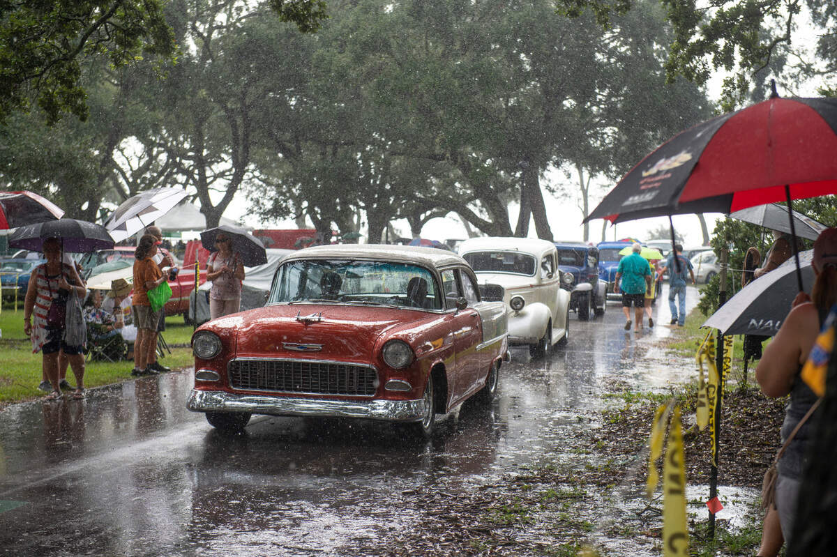 Cars leave Centennial Plaza as it pours during registration for Cruisin’ The Coast on Monday, Oct. 4, 2021.