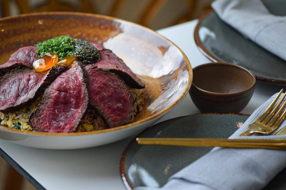 The wagyu fired rice with green onion, soy cured yolk and caviar at Toro Sushi and Sake.