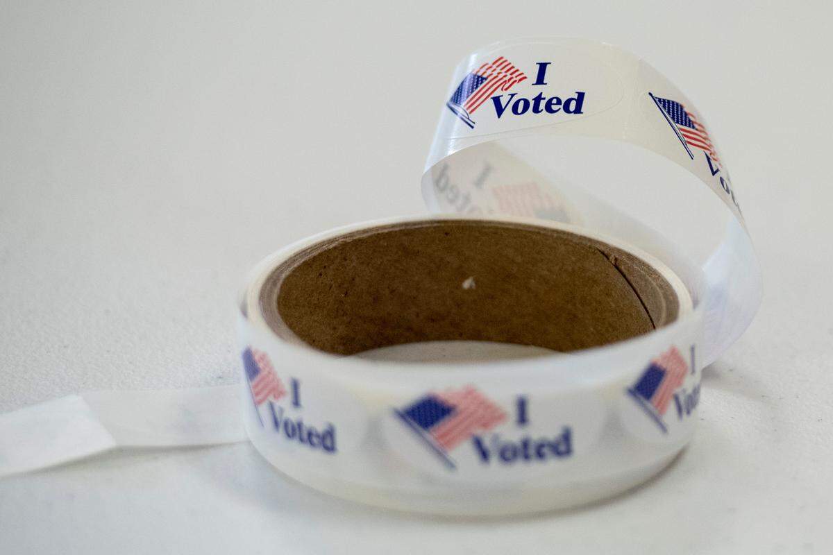 Voting stickers sit on a table at St. Martin Community Center, a polling place in Mississippi’s primary election, on Tuesday, June 7, 2022.
