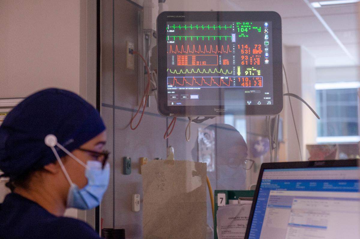 A nurse works at a computer station in the ICU at Memorial Hospital in Gulfport on Wednesday, Aug. 11, 2021.