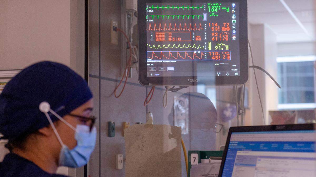 A nurse works at a computer station in the ICU at Memorial Hospital in Gulfport on Wednesday, Aug. 11, 2021.