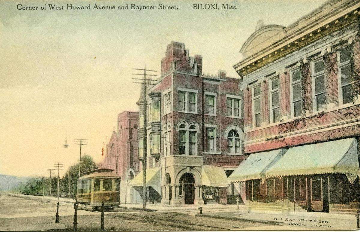 This Biloxi postcard of the corner of “West Howard Avenue and Raynoer Street (now Reynoir Street)” shows the Barq Building in the right foreground.
