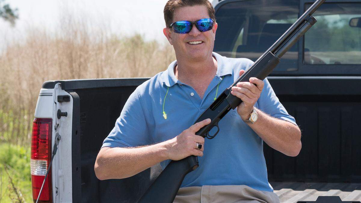 LISA MARIE PANE/ASSOCIATED PRESSJonathan Mossberg, whose iGun Technology Corp. is working to develop a "smart gun," poses with the firearm on April 7, 2016, in Daytona Beach, Fla. The firearm uses a ring to send a signal to prevent anyone but an authorized user from firing the weapon.