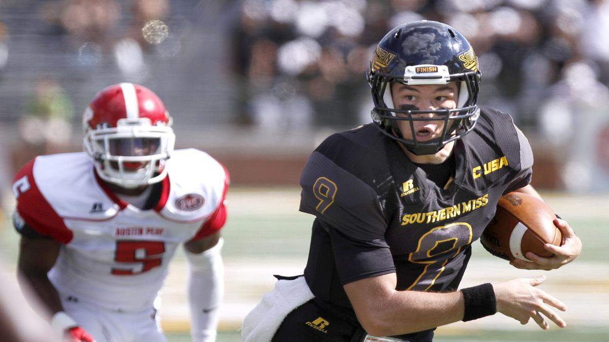 TIM ISBELL/SUN HERALD 
 Southern Miss quarterback Nick Mullens scrambles for a first down against Austin Peay, Saturday, Sept. 12, 2015.