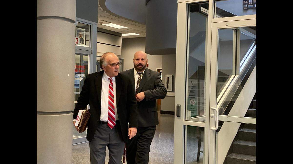 Attorney Keith Pisarich accompanies Gautier police Officer Friedrich “Fred” Carl Paetow to court in Biloxi to face misdemeanor charges.