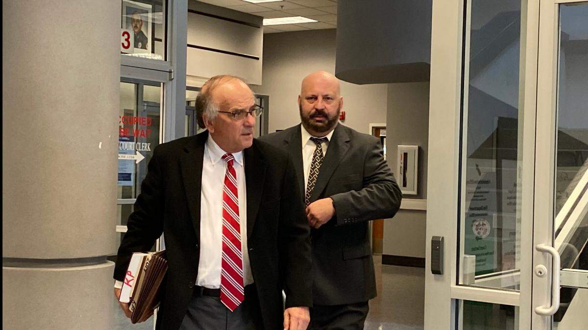 Attorney Keith Pisarich accompanies Gautier police Officer Friedrich “Fred” Carl Paetow to court in Biloxi to face misdemeanor charges.