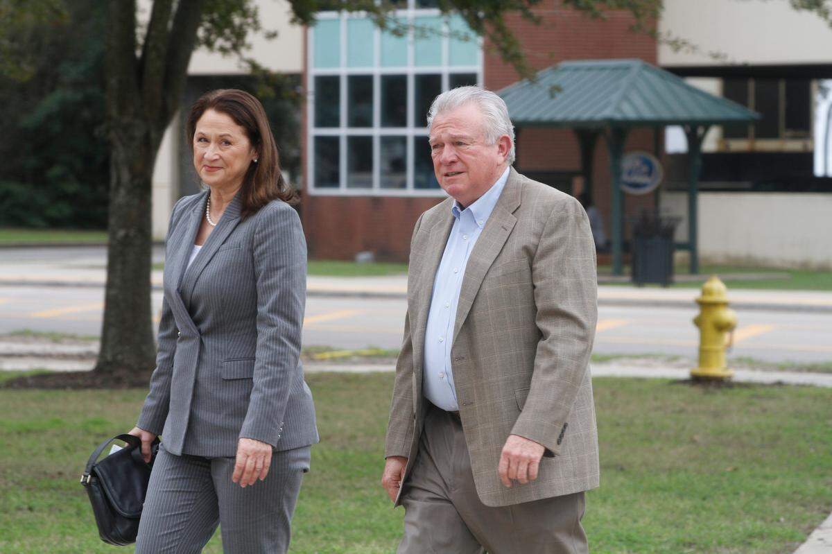 Julie and Ted Cain of Ocean Springs walk toward the federal courthouse in Gulfport on Wednesday for opening arguments in the U.S. government’s civil case against them. The government says they defrauded Medicare of millions, but the Cains deny any wrongdoing.