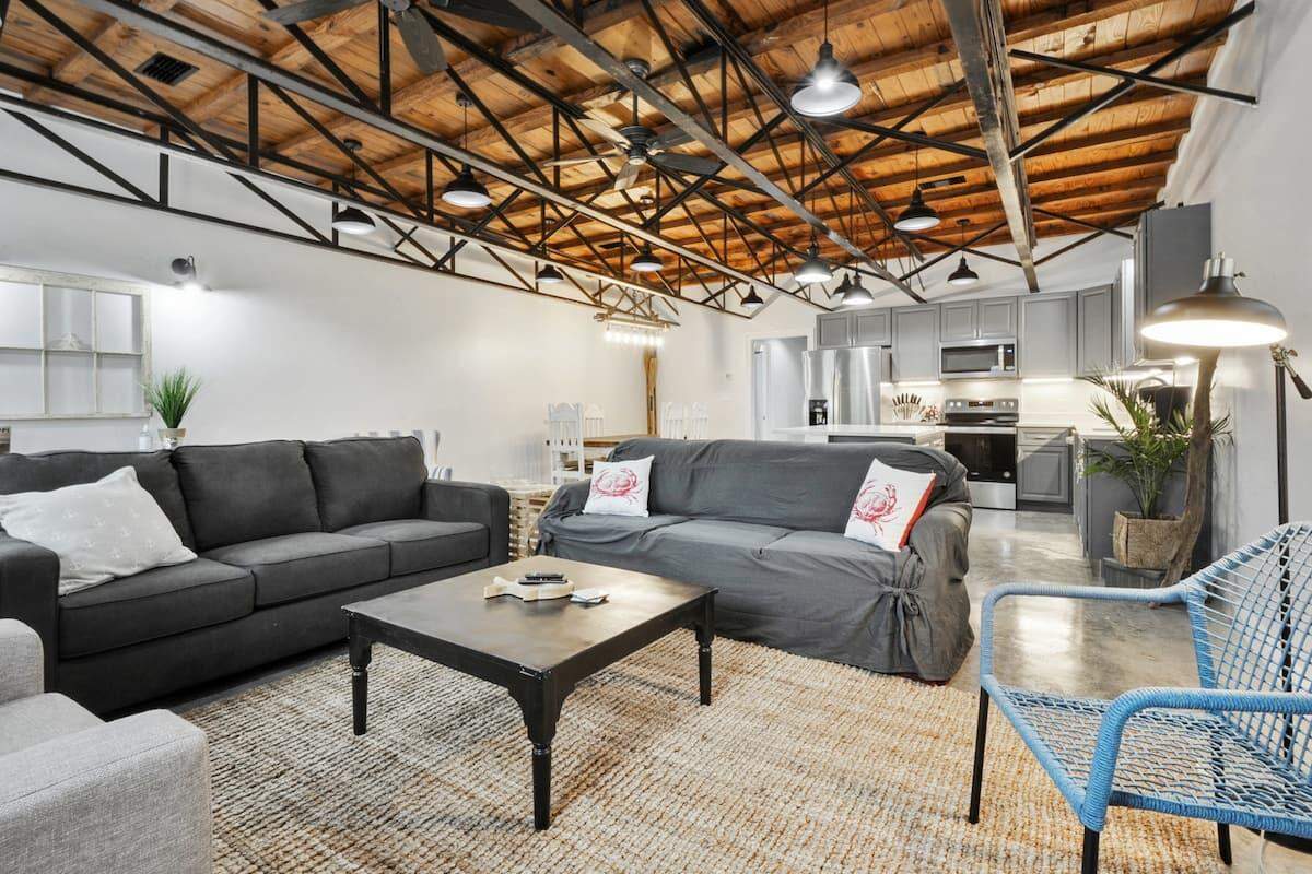 The interior of Katy and Gus Aime’s AirBnb features the original wood ceiling that was restored as well as new furnishings and high end appliances.