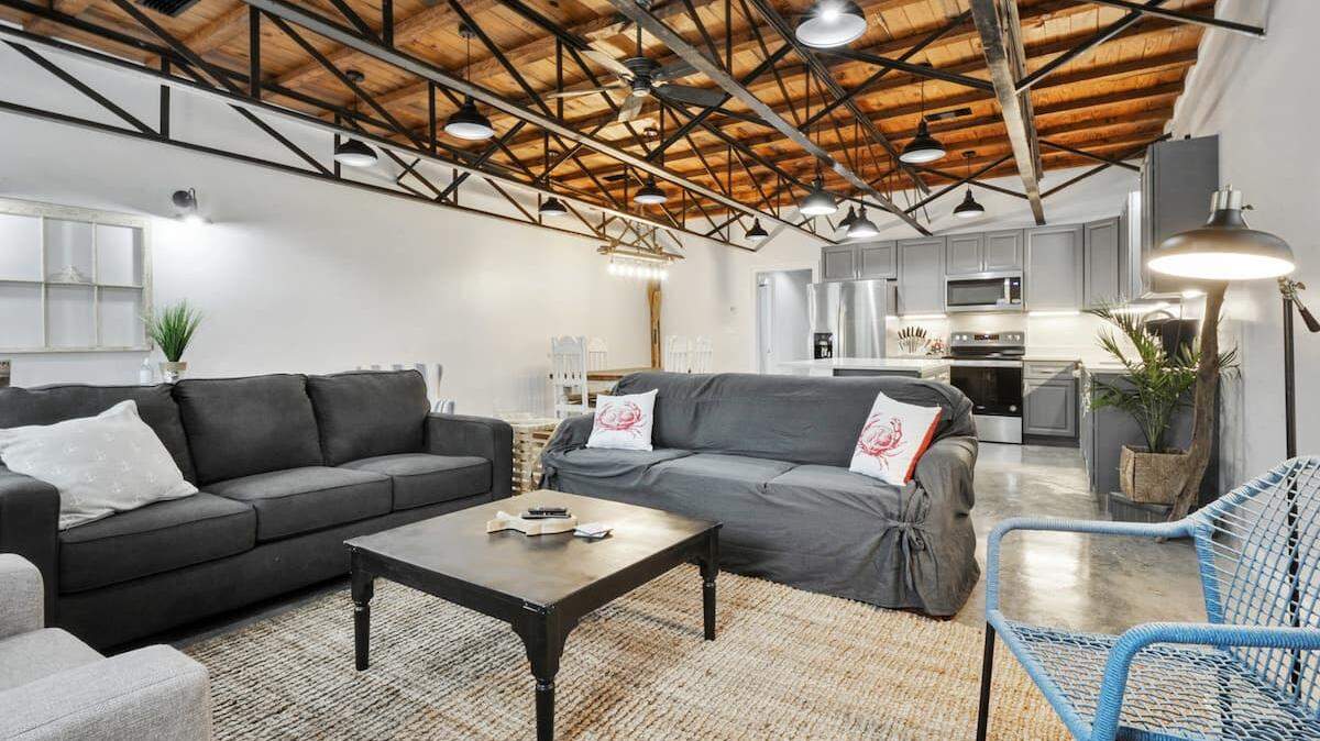 The interior of Katy and Gus Aime’s AirBnb features the original wood ceiling that was restored as well as new furnishings and high end appliances.