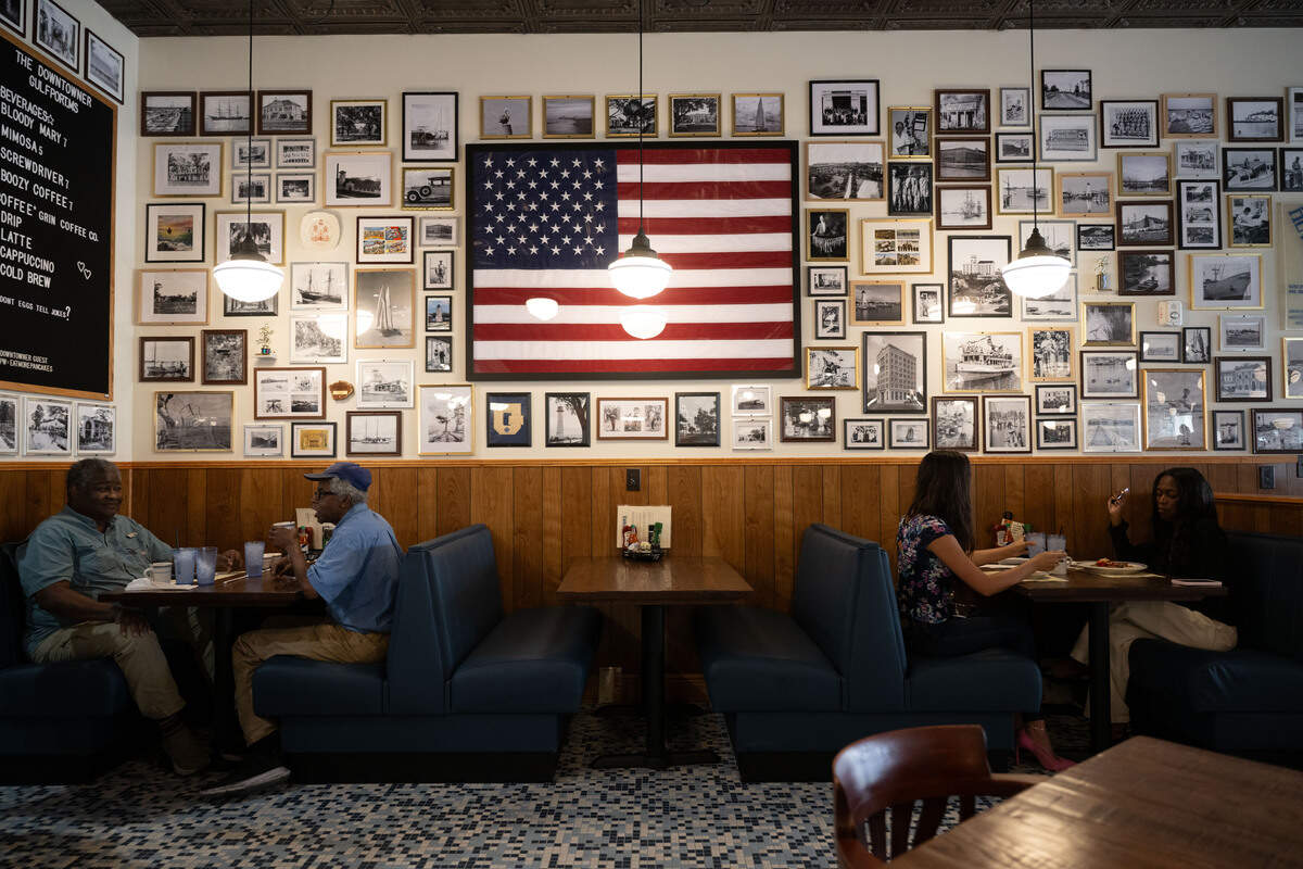 Customers are seated in booths during the opening day of The Downtowner in Gulfport on Tuesday, June 9, 2026.