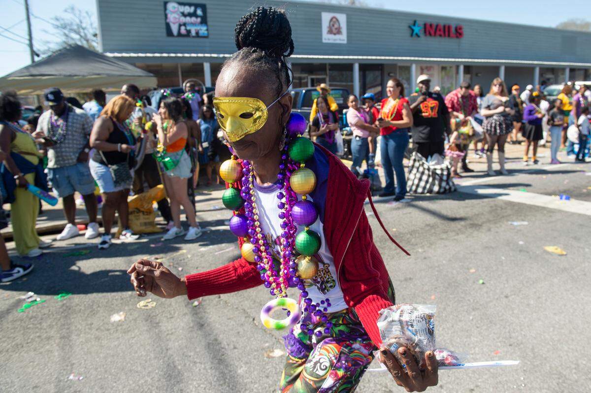 A reveler wears a mask during the Jackson County Carnival Association Mardi Gras parade in Pascagoula in 2025.