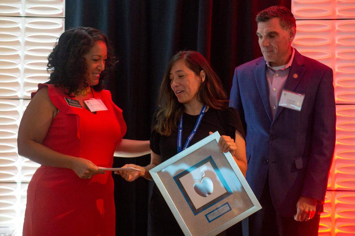 Erica Yong van Norden, from the Pass Christian School District, accepts a Leo W. Seal award and grant from Alisha Johnson Perry and Shane Loper during the Leo W. Seal awards luncheon at the Great Southern Club in Gulfport on Friday, Aug. 26, 2022.