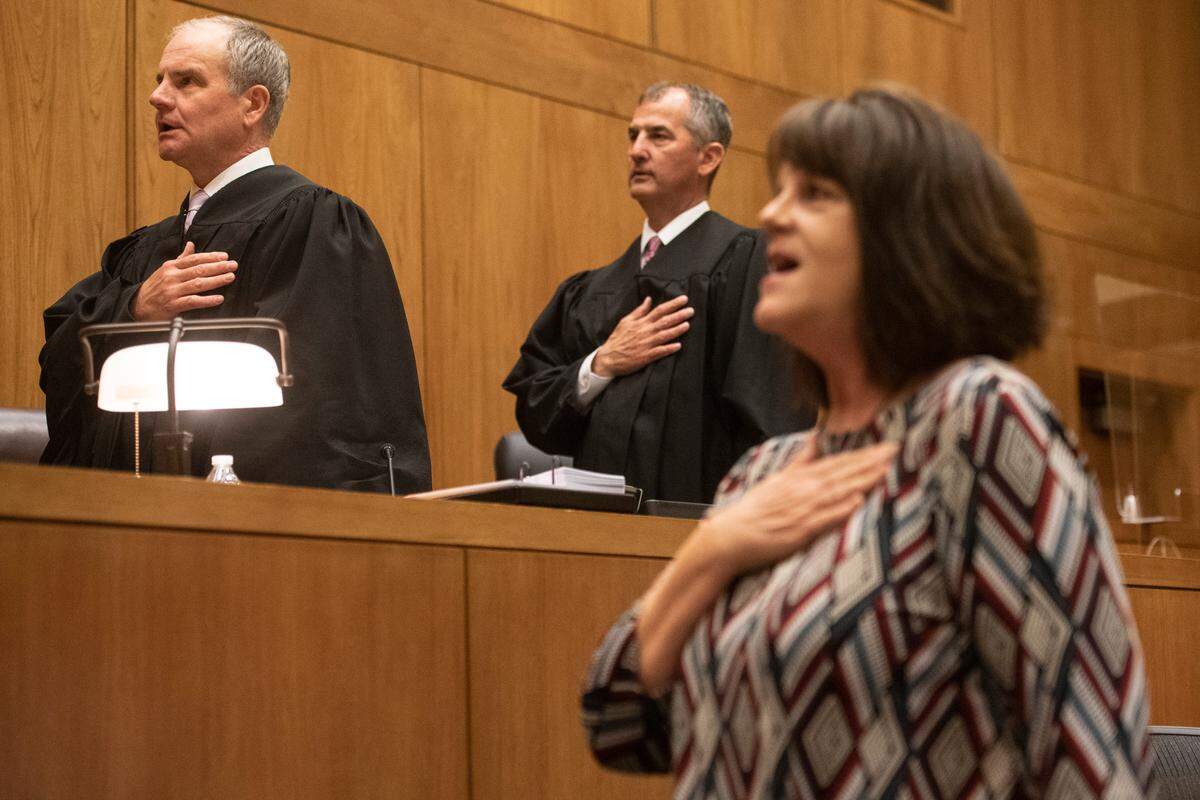 U.S. District Judge Halil Ozerden leads the pledge of allegiance for a group of newly naturalized citizens during a naturalization ceremony at Dan M. Russell Jr. Federal Courthouse in Gulfport on Friday, Oct. 7, 2022.
