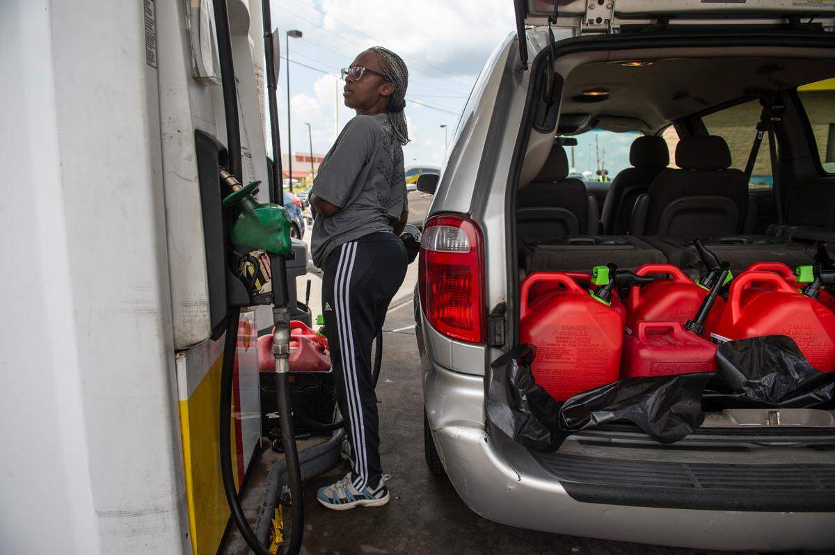 Melonie Pichon, of Marrero, Louisiana fills up her gas tank at a Shell gas station in Gulfport on Wednesday, Sept. 1, 2021. Pichon and her father were filling up with fuel to bring back to senior citizens who didn’t have fuel as the power remains out in parts of Louisiana.