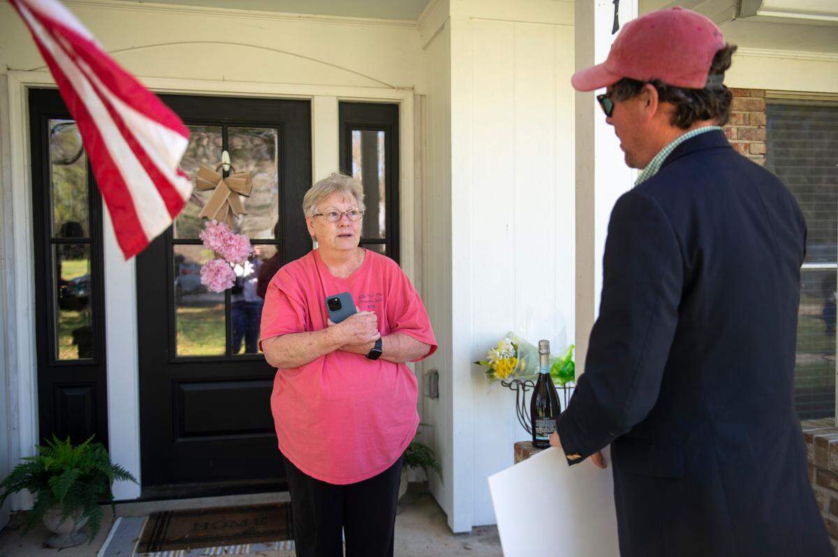 Sandra Bomar reacts as Publishers Clearing House Prize Patrol member Howie Guja tells her Timothy Bomar has won a $50k prize in Ocean Springs on Wednesday, March 19, 2025.