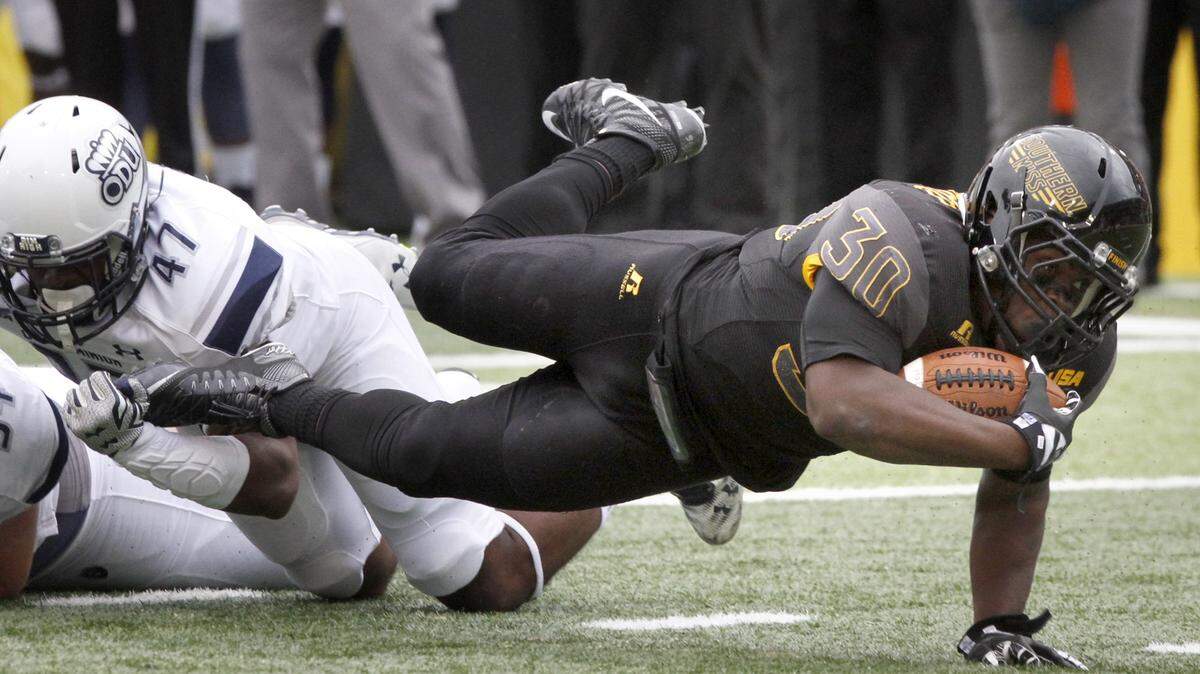 TIM ISBELL/SUN HERALDSouthern Miss running back Jalen Richard dives for extra yards as his is brought down by Old Dominion's T. J. Ricks, Saturday, Nov. 21, 2015.