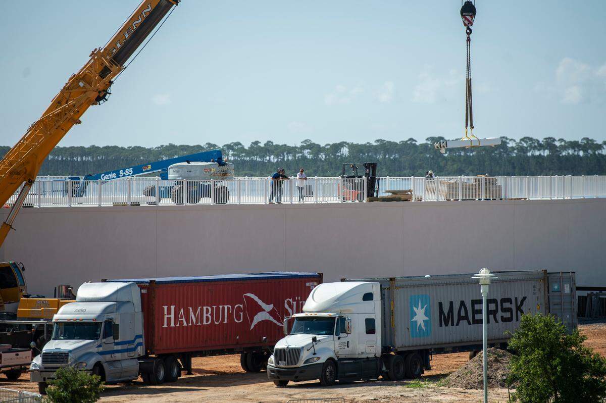 A piece of a new amusement park ride is lifted out of a truck during the assembly of the rides at Paradise Pier Fun Park at Margaritaville Resort in Biloxi on Wednesday, June 1, 2022.
