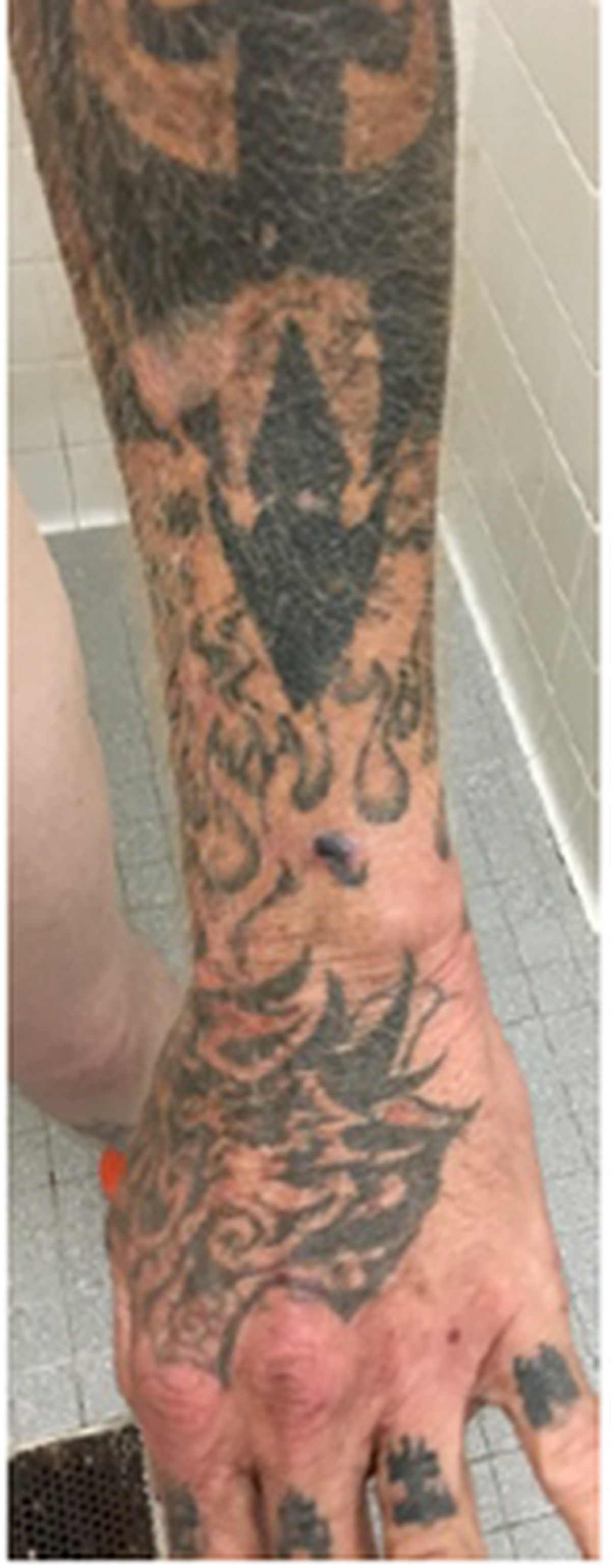 A tattoo on Michael Shun Schaffran, who is wanted by Gulfport Police after allegedly robbing Gulfport Premium Outlets.