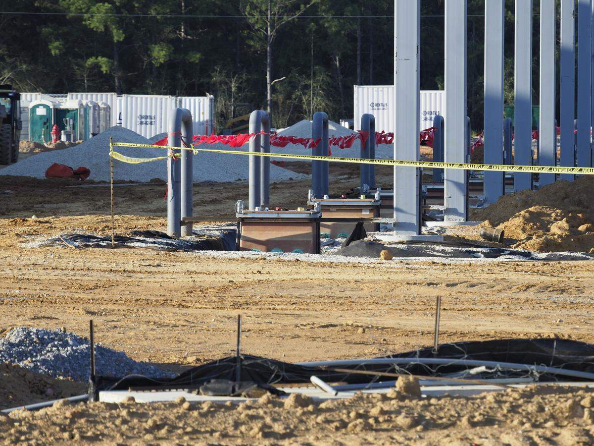 Curved gas pump mounts are in place at the new Buc-ee’s travel center in Harrison County, along with poles to hold the awnings to shade the 120 fueling stations.