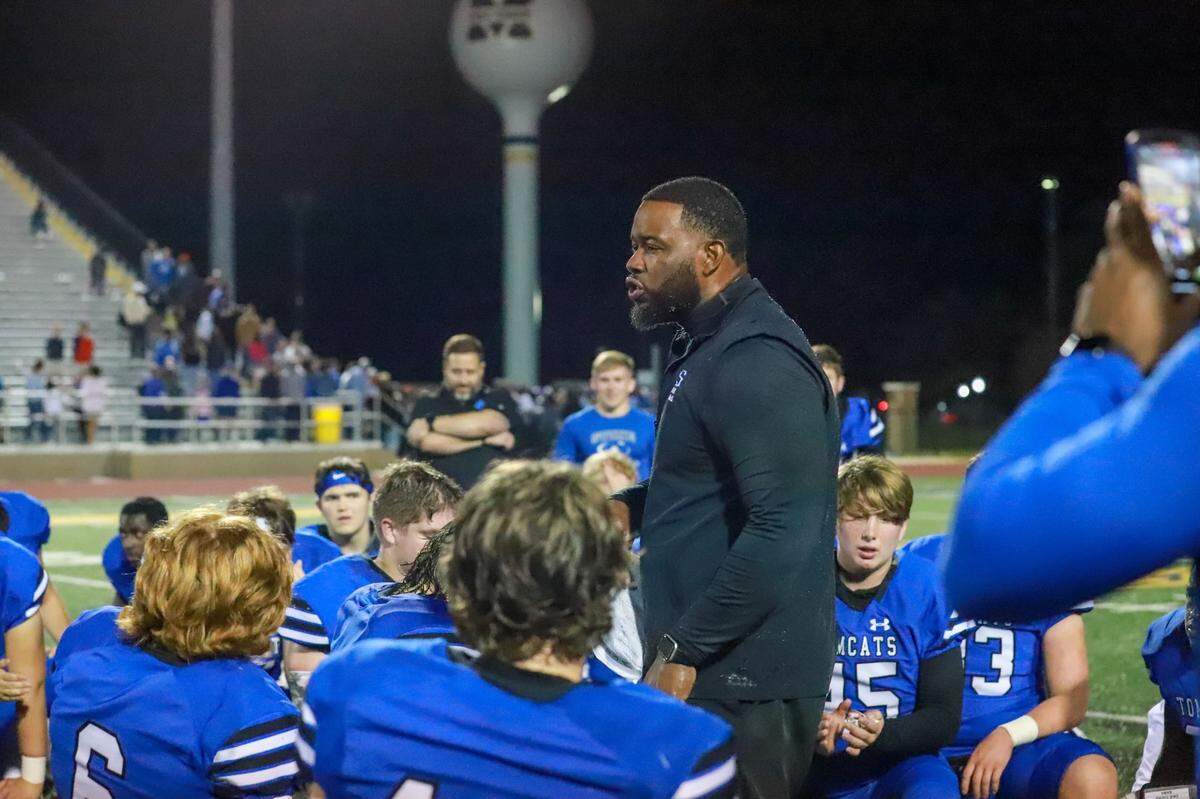 Stone football coach John Feaster speaks with his team after a home game.