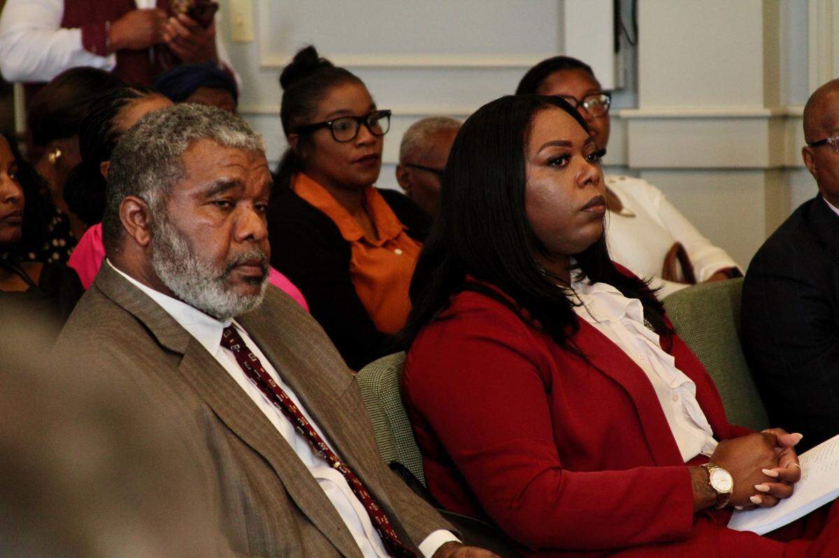 Carrissa Corbett, right, a Democratic candidate for Ward 6 City Council in Gulfort, sits with her attorney, Warren Conway, as incument Republican R.Lee Flowers challenges her residency.