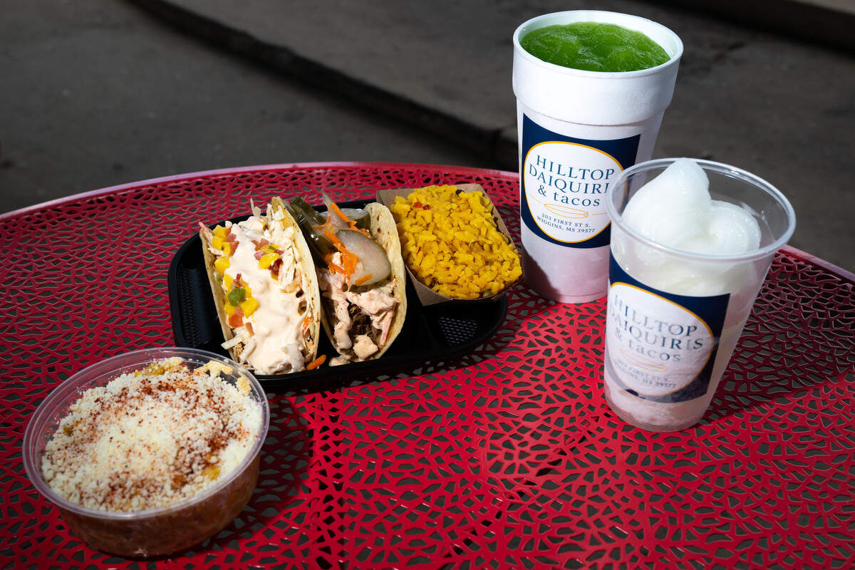 From left to right; the street corn, Baja taco with chicken, Korean taco with pork, a sour apple daiquiri and a soft serve margarita at Hilltop Daiquiris & Tacos in Wiggins on Tuesday, June 23, 2026.