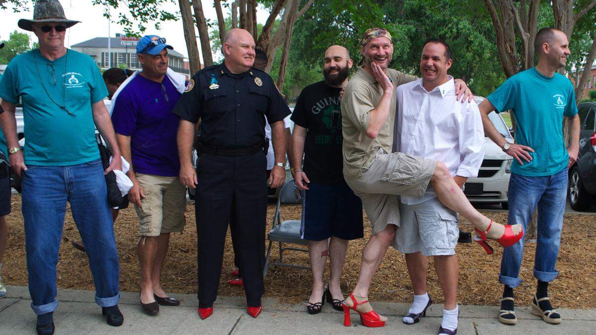 PRISCILLA LOEBENBERG/SPECIAL TO SUN HERALD/2012High-heeled troops from Keesler Air Force Base and Naval Construction Battalion Center Gulfport and the Biloxi Police Chief John Miller joined Ocean Springs Hospital and friends of the Gulf Coast Women's Center for Nonviolence in 2012 for the first Walk a Mile in Her Shoes event. This year's event is Friday.