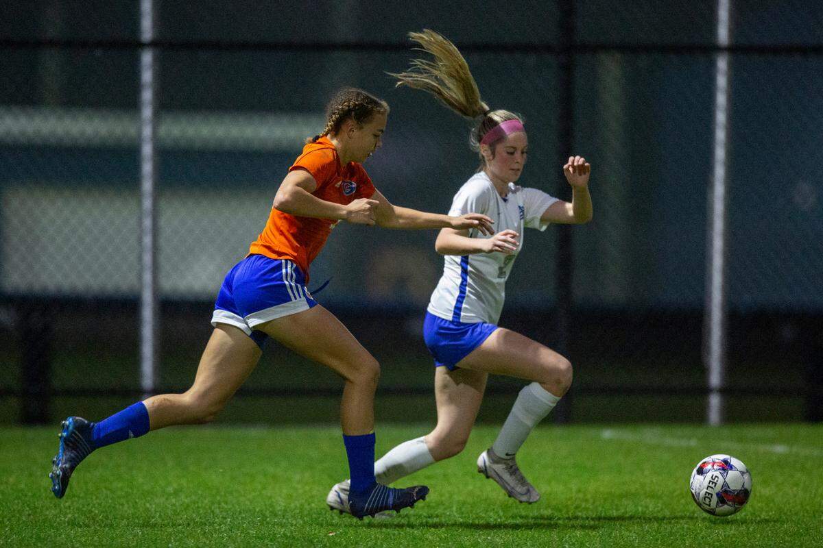 Gulfport’s Abigail Badurak and Ocean Springs’ Megan Hughes fight for the ball during the 6A South State Championship game in Gulfport on Tuesday, Jan. 31, 2023.