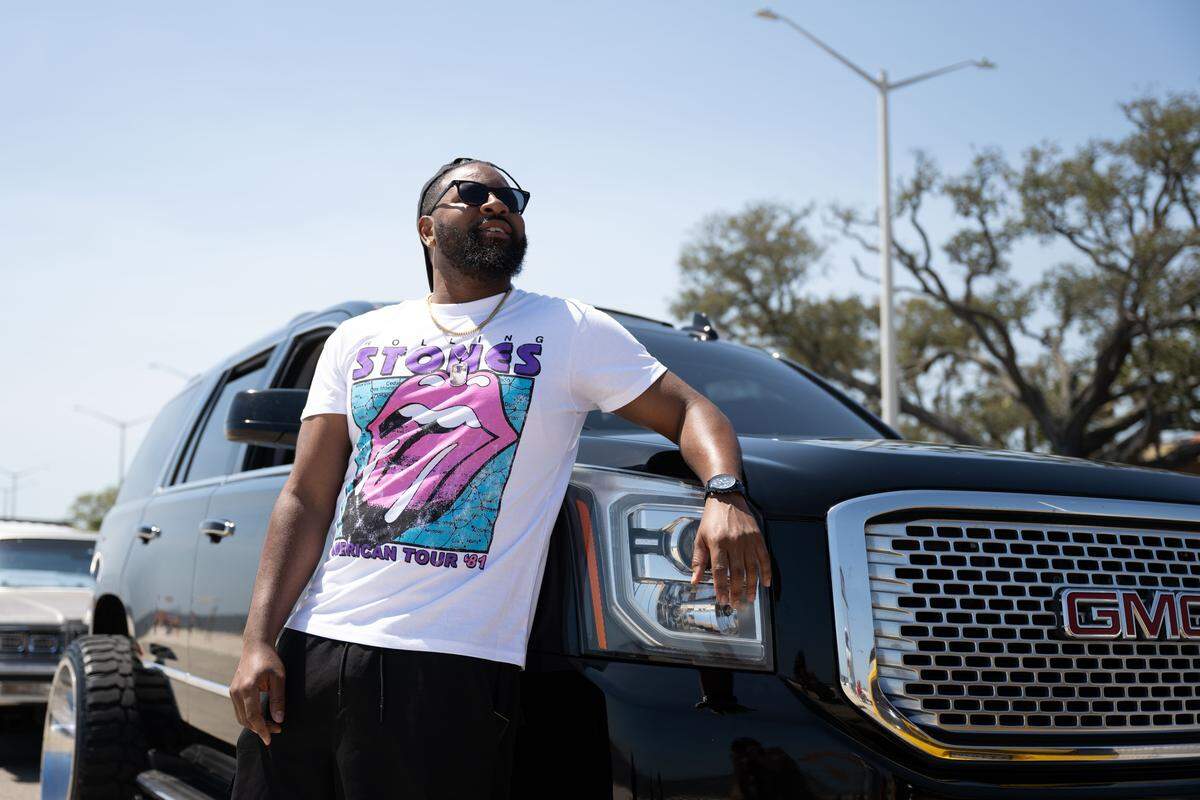 A Black Spring Break visitor poses Saturday for a photo at Biloxi Beach.  “You look down this road right now, you see just as many cop cars as you see regular cars.”