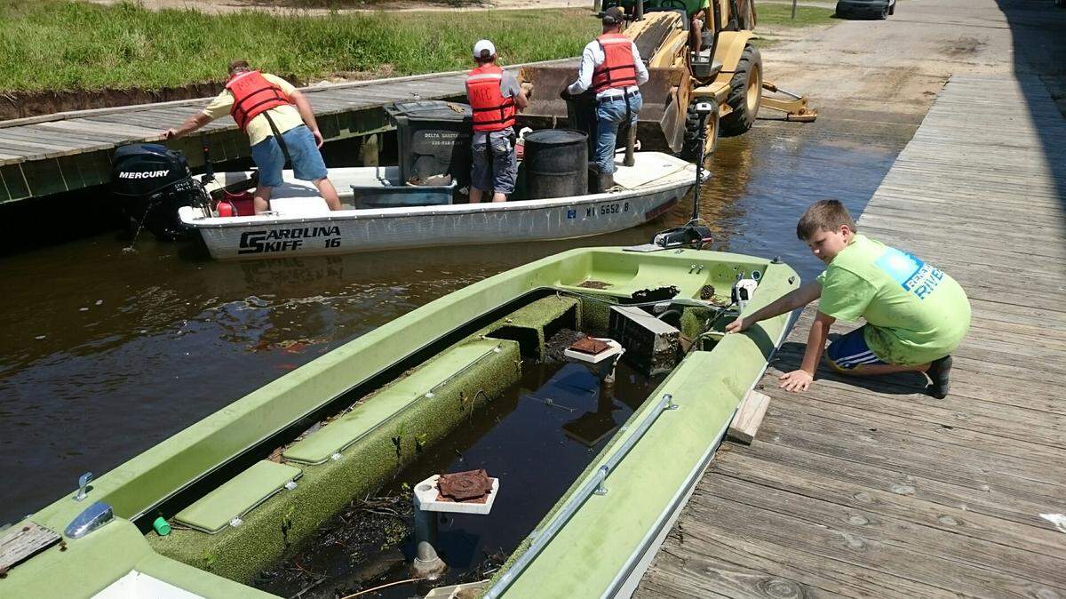 GORDON JACKSON/SPECIAL TO THE SUN HERALD 
 This 16-foot bass boat was among the 2.5 tons of debris taken out of Back Bay during Mississippi Power's 'Renew Our Rivers' cleanup campaign, held Friday.