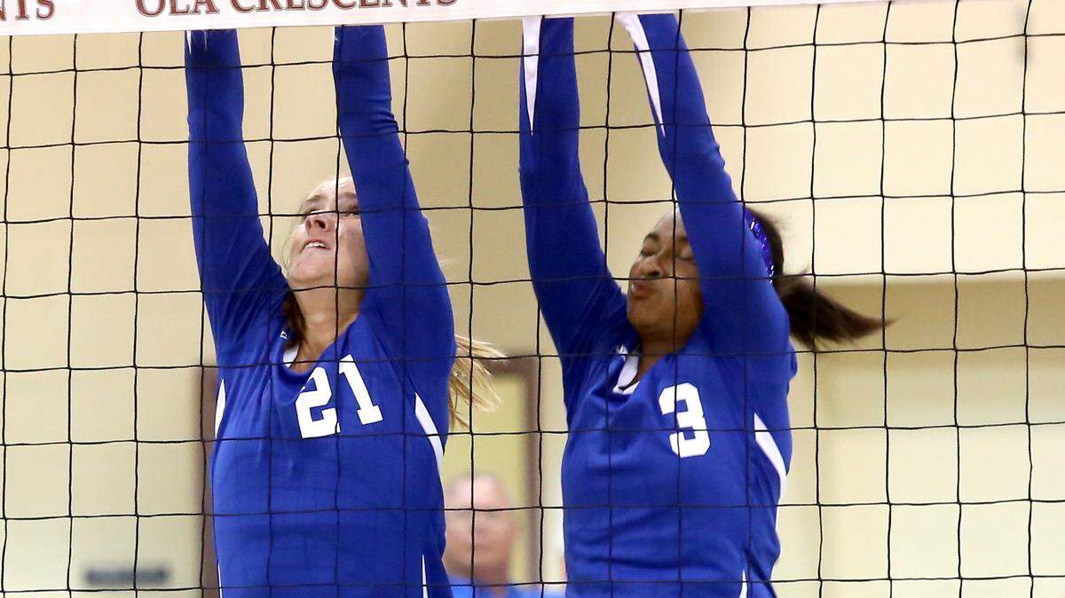AMANDA McCOY/SUN HERALD 
 Resurrection's Shannon Unger, left, and Daja Cowan attempt to block a ball spiked by Our Lady Academy on Tuesday, September 22, 2015, in Bay St. Louis.