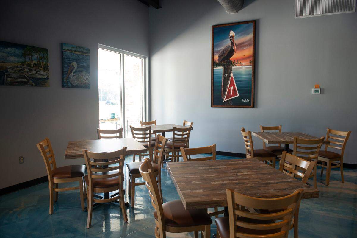 The dining area at Flatheads and Bottom Feeders in Woolmarket on Wednesday, Aug. 7, 2024. The restaurant has a separate dining area and bar.